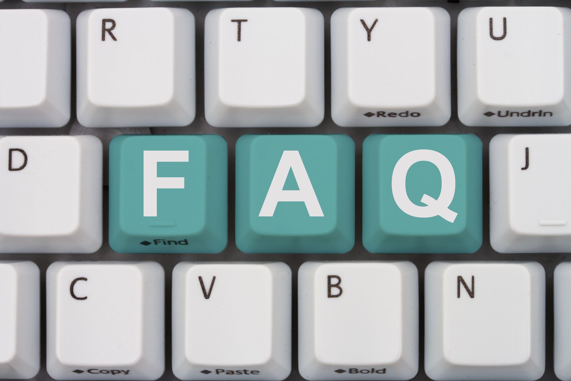 A close up of a keyboard with faq written on the keys