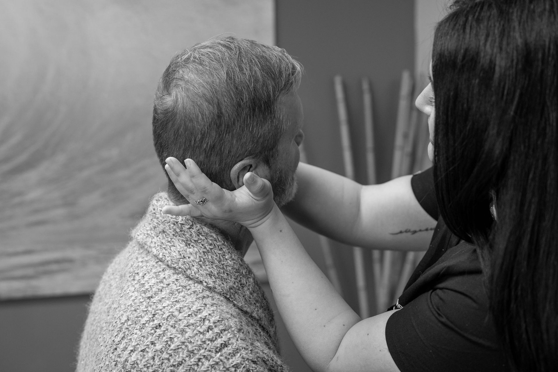 A black and white image of one of our doctors practicing chiropractic techniques.